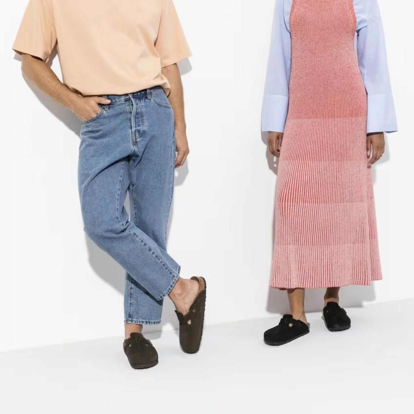 To personer iført moderne tøj: mand i lyseblå jeans og ferskenfarvet t-shirt, kvinde i lang, lyserød kjole. Begge bærer sorte Birkenstock-sko.