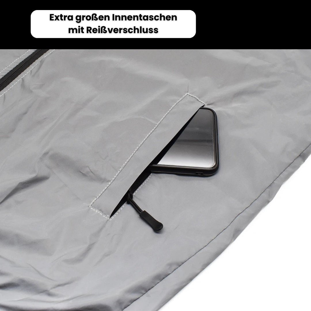 Grå jakke med stor indvendig lomme og lynlås, der viser en smartphone. Praktisk design til sikker opbevaring.
