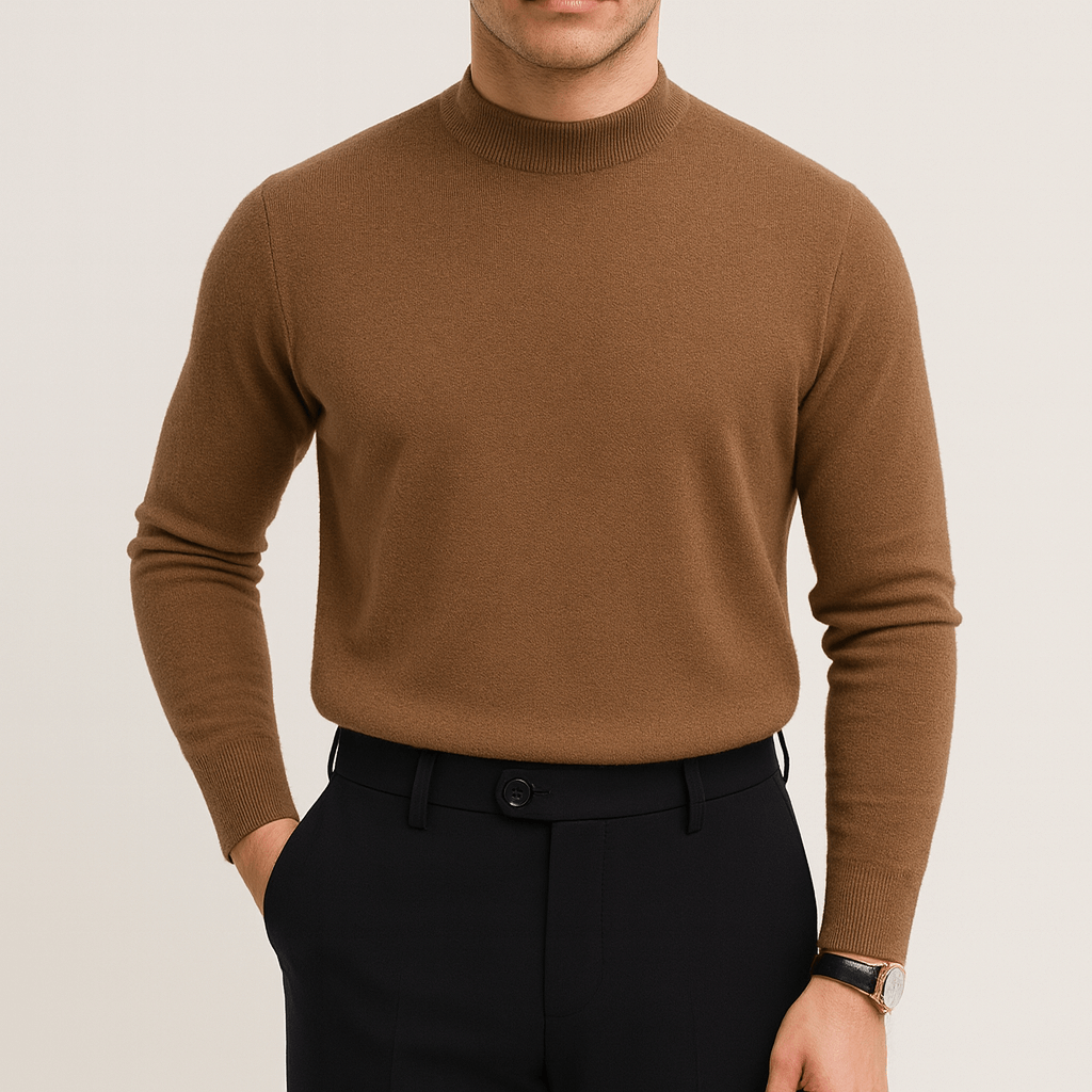 Mand iført brun rullekrave sweater og sorte bukser, stilfuldt herretøj, moderne mode, minimalistisk design, elegant look, efterårstøj.
