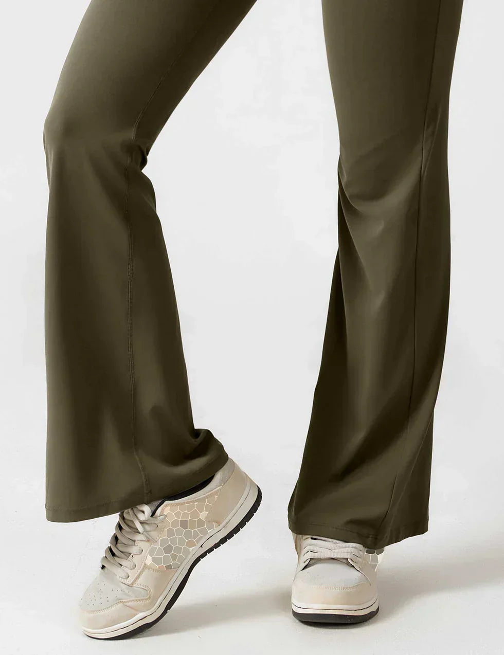 Grønne bukser med vidde ben og beige sneakers med mønster. Komfortabelt og stilfuldt outfit til hverdagsbrug. Mode, tøj, sko.