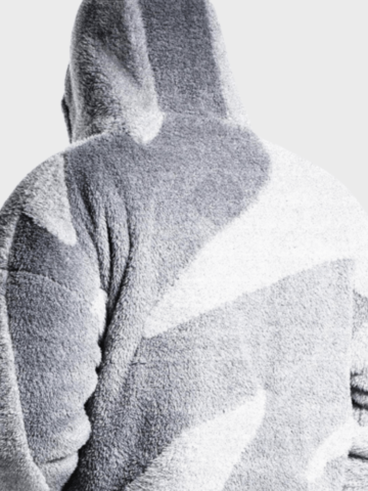 Grå og hvid camouflage hættetrøje i fleece, set bagfra. Komfortabelt og stilfuldt vintertøj, perfekt til udendørs aktiviteter og afslappet brug.