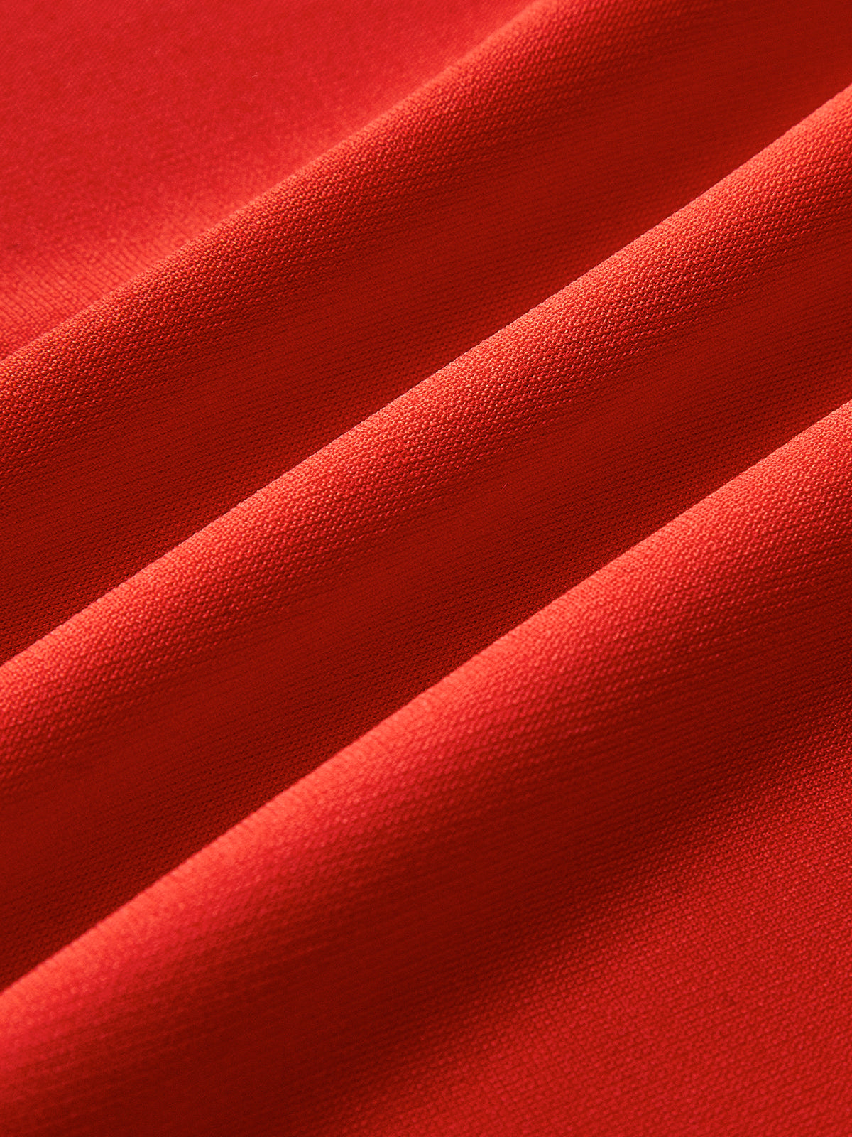 Rød tekstilstof med bløde folder, tæt vævet struktur. Ideel til mode, boligindretning, syning. Høj kvalitet, levende farve, holdbar.