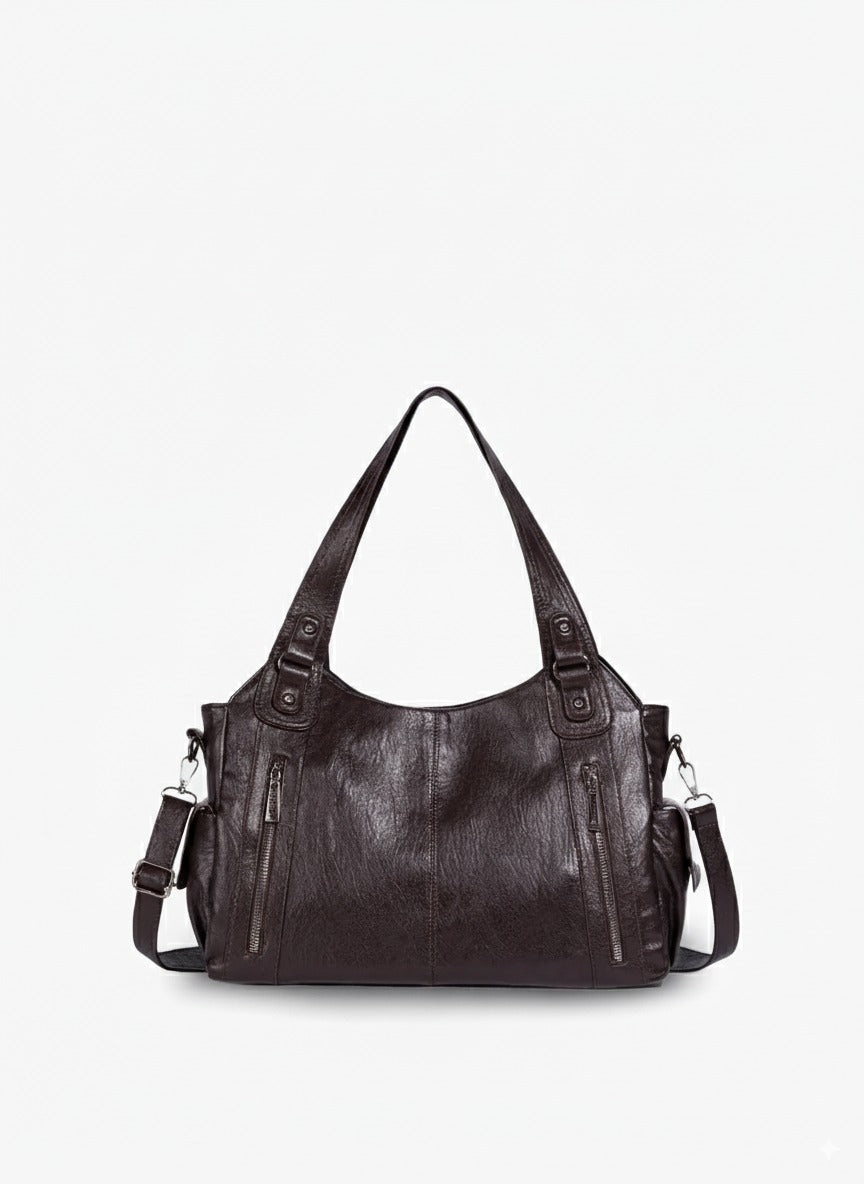 Mørkebrun læderhåndtaske med justerbar skulderrem og lynlåslommer. Elegant design, ideel til hverdagsbrug. Perfekt til modebevidste kvinder.