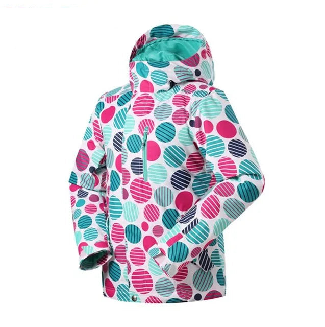 Farverig børne vinterjakke med cirkelmønster i pink, blå og turkis. Vandtæt og vindtæt design, ideel til koldt vejr. Justerbar hætte.
