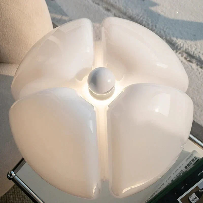 Hvid moderne loftlampe med blomstret design, skinnende overflade og blødt lys, ideel til stilfuld indretning og belysning i hjemmet.