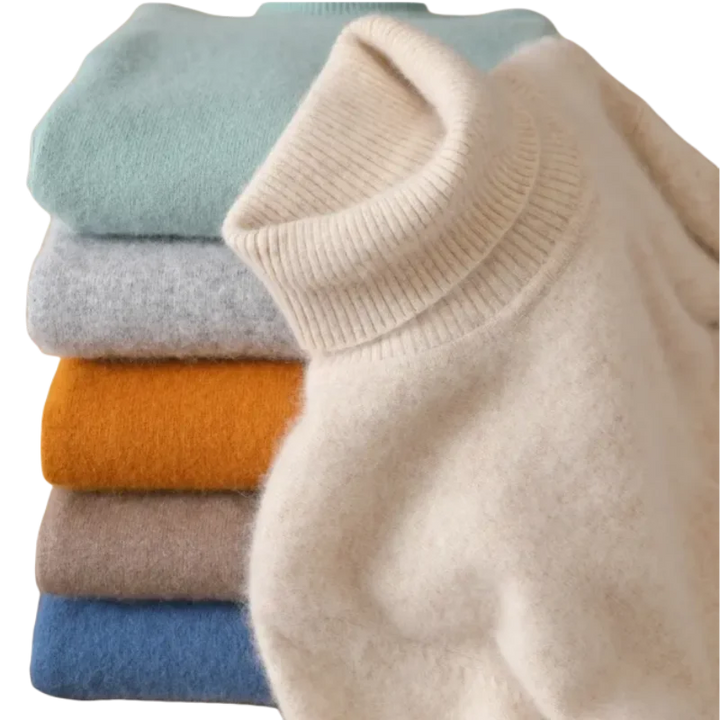 Stabel af farverige kashmirtrøjer med rullekrave i beige, blå, grå, orange og brun. Bløde, luksuriøse materialer til vintermode.