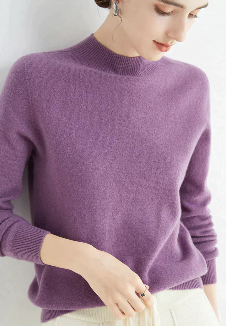 Kvinde iført lilla cashmere sweater, minimalistisk design, blød tekstur, elegant stil. Perfekt til efterårsmode og komfortabelt hverdagslook.