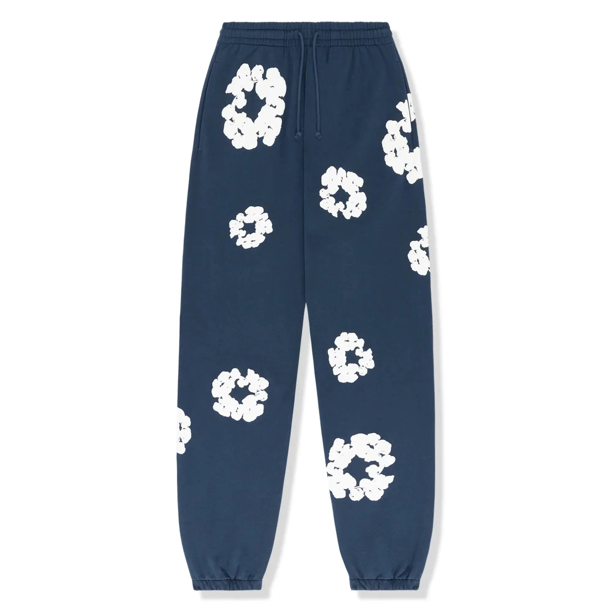 Mørkeblå joggingbukser med hvide blomsterprint, elastisk talje og manchetter. Trendy afslappet stil, perfekt til hverdagsbrug.